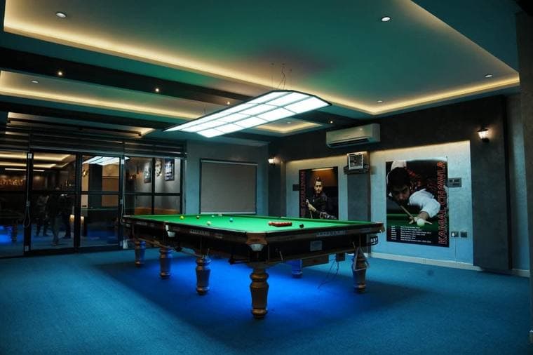 Snooker tables under blue light